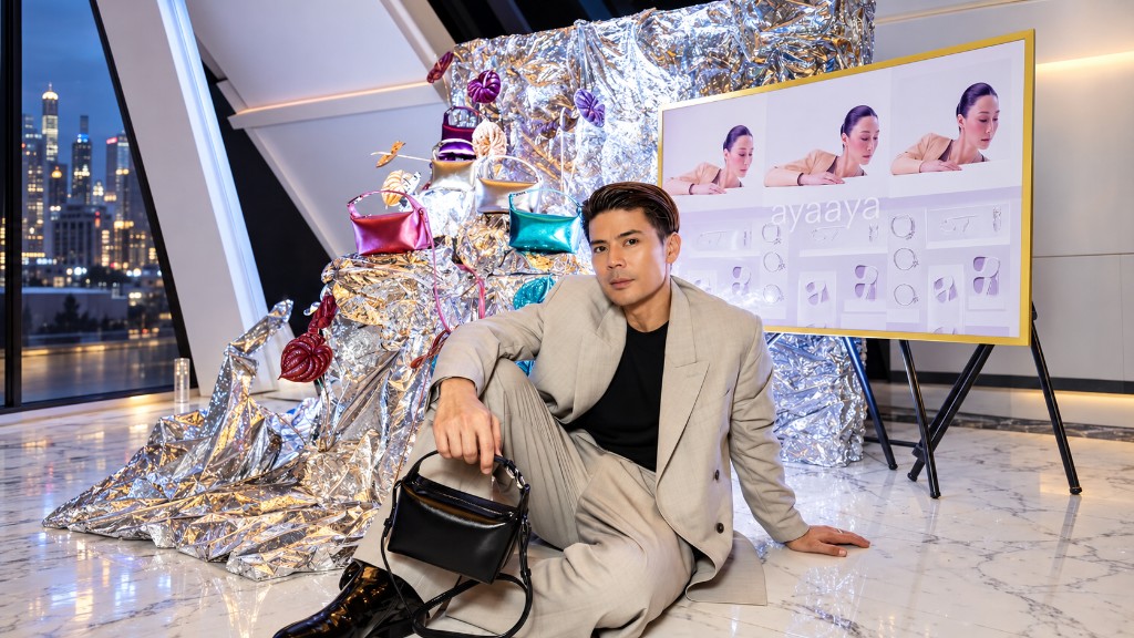 Ayaaya brand launch styling with a silver foil installation, colourful handbags and city-view venue.